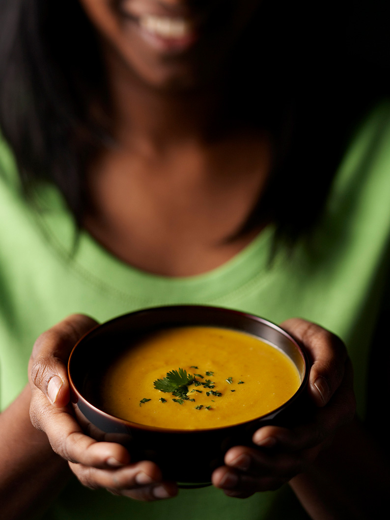 Studio shot using a model in complementary colours lit to convey the warming nature of soup.