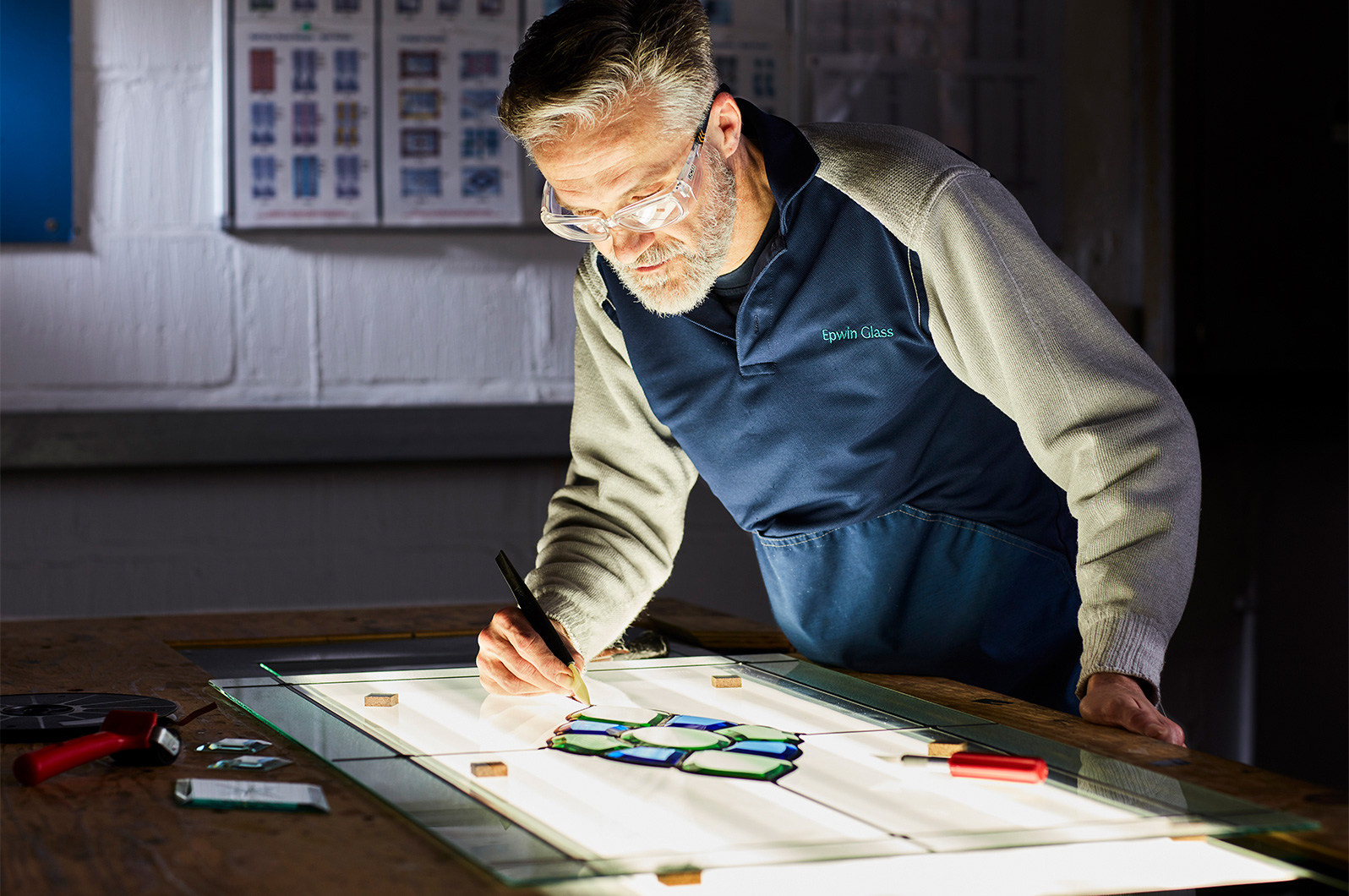 Shot on location at the factory to highlight the hands on skill of the decorative glass panels.